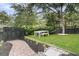 Inviting backyard with lush greenery, a dining set, and a black fence creating a private outdoor oasis at 300 Ginned Cotton St, Charleston, SC 29492