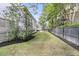 Expansive backyard featuring lush greenery, a black fence, and well-maintained landscaping for outdoor enjoyment at 300 Ginned Cotton St, Charleston, SC 29492