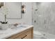 Elegant bathroom featuring a modern vanity, marble countertop, and glass-enclosed shower at 300 Ginned Cotton St, Charleston, SC 29492