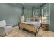 Coastal-style bedroom with wood-framed bed, soothing wall color, and natural light from shuttered windows at 300 Ginned Cotton St, Charleston, SC 29492