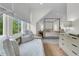 Serene bedroom with a four-poster bed, daybed, and large windows offering ample natural light at 300 Ginned Cotton St, Charleston, SC 29492