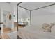 Inviting bedroom with a four-poster bed, daybed, and large windows offering ample natural light at 300 Ginned Cotton St, Charleston, SC 29492