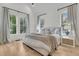 Bright bedroom with hardwood floors, neutral decor, and ample natural light at 300 Ginned Cotton St, Charleston, SC 29492