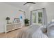 A serene primary bedroom is filled with natural light, complemented by wood floors and cozy decor at 300 Ginned Cotton St, Charleston, SC 29492