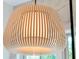A contemporary chandelier with wood slats adds a unique, designer touch to this space at 300 Ginned Cotton St, Charleston, SC 29492