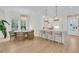 Bright dining and kitchen area featuring a large window, chandelier, and kitchen island with barstool seating at 300 Ginned Cotton St, Charleston, SC 29492