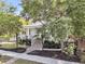 Charming white home with a welcoming front porch, brick stairs, and mature trees at 300 Ginned Cotton St, Charleston, SC 29492