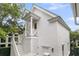 Charming white exterior with stairs leading to a covered porch and a side entrance adding architectural interest at 300 Ginned Cotton St, Charleston, SC 29492