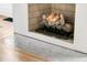 Close-up view of a cozy fireplace with decorative stone surround and hearth at 300 Ginned Cotton St, Charleston, SC 29492