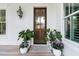 Inviting front door with sidelight window and decorative plants at 300 Ginned Cotton St, Charleston, SC 29492