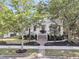 Charming white cottage-style home with a brick pathway and manicured landscaping at 300 Ginned Cotton St, Charleston, SC 29492