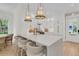 Bright, modern kitchen with a spacious island, pendant lighting, and white cabinetry at 300 Ginned Cotton St, Charleston, SC 29492