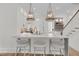 Stylish kitchen with white cabinets, a quartz countertop island, and elegant pendant lights at 300 Ginned Cotton St, Charleston, SC 29492