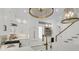 Kitchen with stainless appliances, mini fridge, and beautiful brass fixtures with view to upstairs at 300 Ginned Cotton St, Charleston, SC 29492