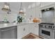 Modern kitchen with stainless steel appliances and white cabinetry with a view to the living area at 300 Ginned Cotton St, Charleston, SC 29492