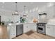 Bright, open kitchen with stainless steel appliances, a Wolf oven, and pendant lighting at 300 Ginned Cotton St, Charleston, SC 29492