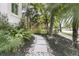 Landscaped walkway with stone pavers surrounded by lush plants and mulch at 300 Ginned Cotton St, Charleston, SC 29492