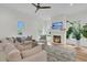 Bright living room with large windows, a modern fireplace, and comfortable seating at 300 Ginned Cotton St, Charleston, SC 29492