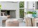 Cozy outdoor porch featuring a fireplace, stylish furniture, and a view of the surrounding nature at 300 Ginned Cotton St, Charleston, SC 29492
