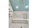 Spacious shower with blue accent tiles, a built-in bench, and multiple shower heads at 300 Ginned Cotton St, Charleston, SC 29492