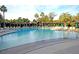 Large swimming pool with plenty of lounge chairs, umbrellas, and trees surrounding the pool area at 300 Ginned Cotton St, Charleston, SC 29492