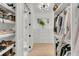 Bright walk-in closet with custom shelving for shoes and clothing plus drawers and window at 300 Ginned Cotton St, Charleston, SC 29492