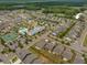 Aerial view of a residential community with a pool and tennis courts at 3006 Cross Vine Ln, Summerville, SC 29483