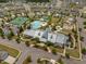 Aerial view of a community clubhouse, pool, tennis courts, and manicured green spaces at 3006 Cross Vine Ln, Summerville, SC 29483