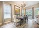Elegant dining room featuring a chandelier, large windows and a painting at 3006 Cross Vine Ln, Summerville, SC 29483