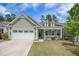 Charming single-story home with a manicured lawn, attached garage, and inviting front porch at 3006 Cross Vine Ln, Summerville, SC 29483