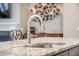 Close-up of a kitchen island featuring a stainless steel faucet and granite countertop at 3006 Cross Vine Ln, Summerville, SC 29483