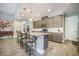 Island with pendant lighting and barstool seating enhances this updated kitchen space at 3006 Cross Vine Ln, Summerville, SC 29483