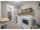 Functional laundry room with washer, dryer, folding table, and pantry storage at 3006 Cross Vine Ln, Summerville, SC 29483