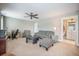 Cozy living room features comfortable seating, ceiling fan, and adjacent bathroom entrance at 3006 Cross Vine Ln, Summerville, SC 29483