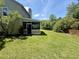 Expansive grassy backyard features a screened-in porch and mature trees for shade and privacy at 319 Parish Park, Summerville, SC 29485
