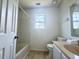 Bright bathroom with tile floors, single vanity, tub/shower combo, toilet and a window at 319 Parish Park, Summerville, SC 29485