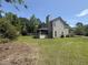 Rear view of the home featuring a screened porch and lush green backyard, perfect for relaxing and entertaining at 319 Parish Park, Summerville, SC 29485