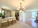 Open concept kitchen features an island, bar stools, and flows into the living area, perfect for entertaining at 319 Parish Park, Summerville, SC 29485