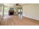 Spacious living room featuring hardwood floors, a brick fireplace, several windows, and a ceiling fan at 319 Parish Park, Summerville, SC 29485