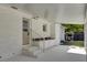 Rear porch with steps, sink, cabinets, and white brick exterior at 32 Elmora Ave, Goose Creek, SC 29445