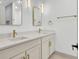 Bathroom features a double sink vanity with modern gold fixtures, mirrors, and lighting at 32 Elmora Ave, Goose Creek, SC 29445