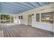 Spacious front porch with a wood floor and blue ceiling offers a comfortable place to relax at 32 Elmora Ave, Goose Creek, SC 29445