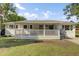 Inviting home featuring a lovely front porch and freshly manicured lawn at 32 Elmora Ave, Goose Creek, SC 29445