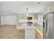 Bright, open kitchen featuring stainless steel appliances, ample counter space, and modern lighting at 32 Elmora Ave, Goose Creek, SC 29445