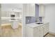 Bright, modern kitchen with island, stainless steel appliances, light countertops, and wood floors at 32 Elmora Ave, Goose Creek, SC 29445
