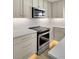 Modern kitchen features stainless steel appliances, white cabinets, and light countertops at 32 Elmora Ave, Goose Creek, SC 29445