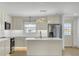 Bright kitchen with stainless steel appliances, stone countertops and a center island at 32 Elmora Ave, Goose Creek, SC 29445