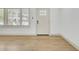 Living room boasts wood floors and natural light near an entry door and window at 32 Elmora Ave, Goose Creek, SC 29445