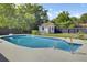 Backyard pool featuring mature trees and a pool house at 32 Elmora Ave, Goose Creek, SC 29445