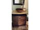 Bathroom vanity with a vessel sink, marble countertop, and a dark wooden cabinet for stylish storage at 330 Concord St # Th17, Charleston, SC 29401